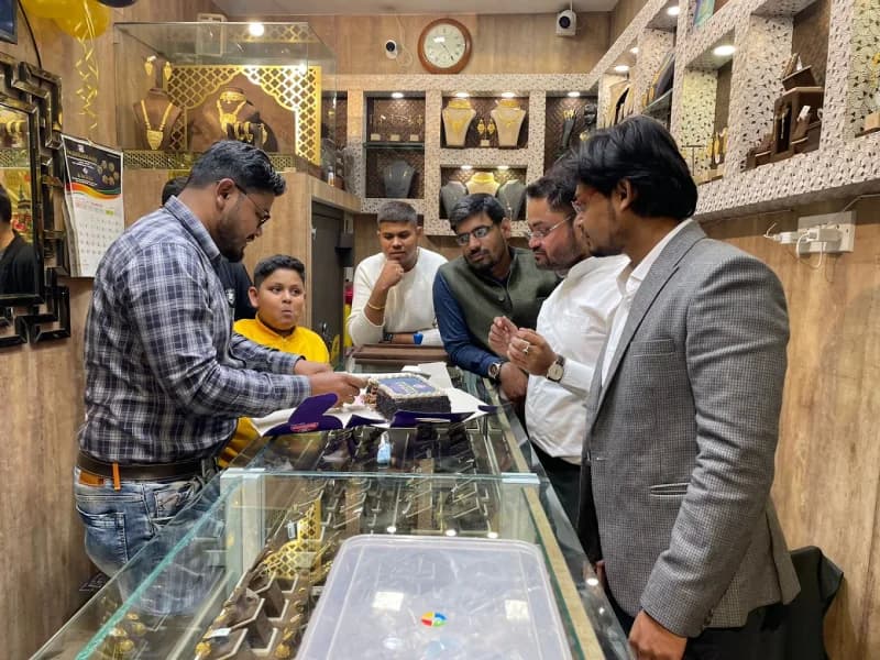 R M Gold staff showing jewellery to customers in-store